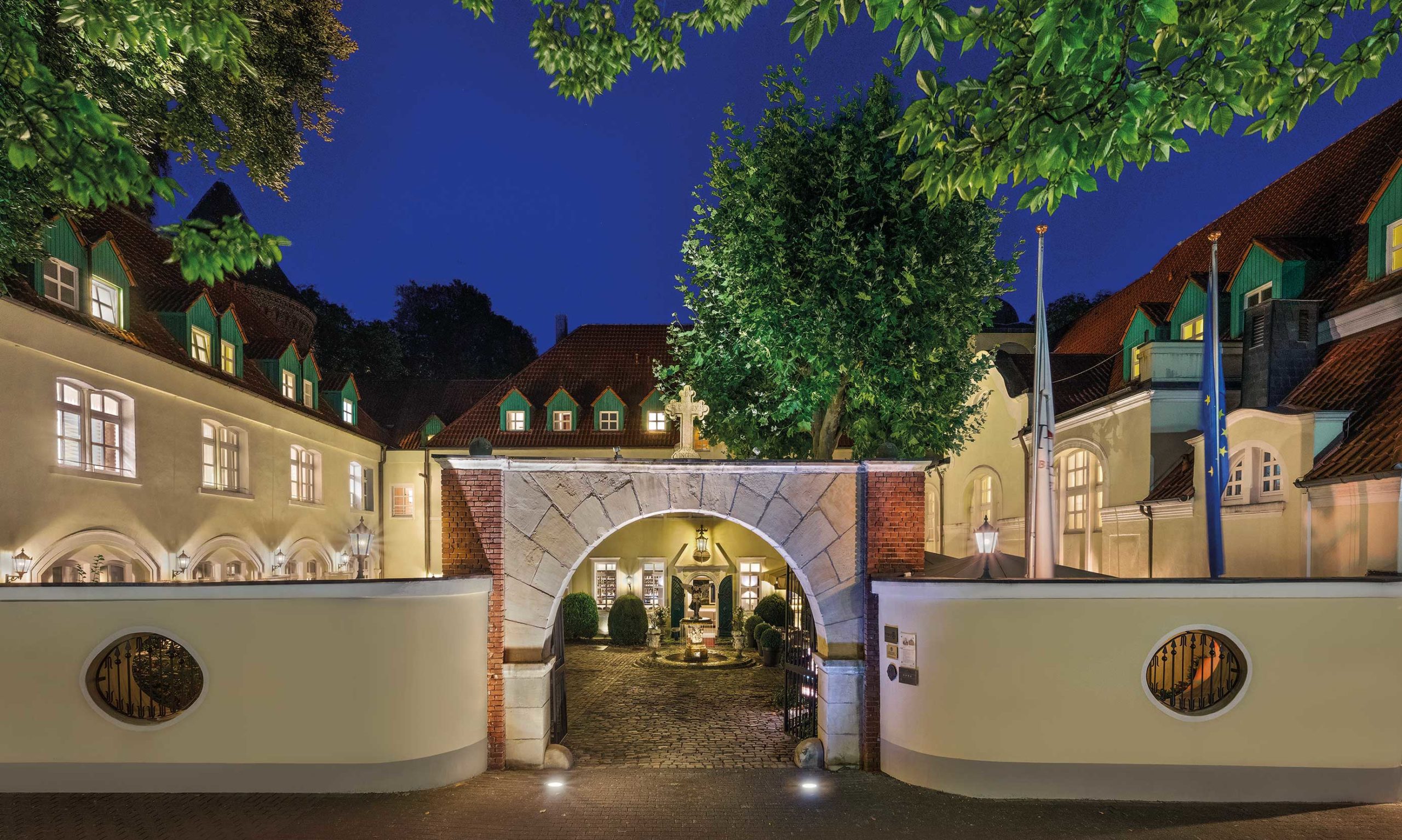 historic gate and grounds of the engelsburg at night monument protection hotel Engelsburg in nrw