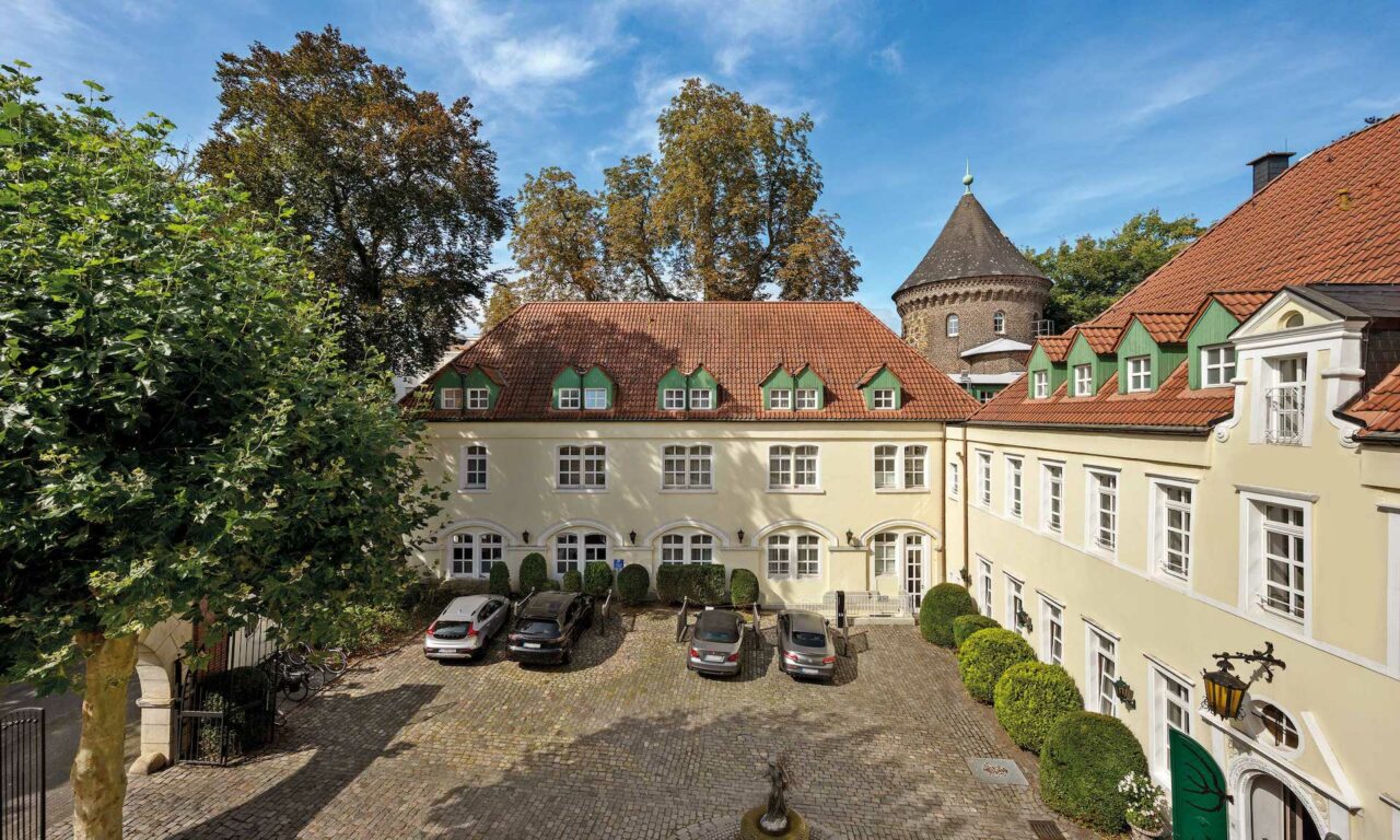 courtyard with parking slots at castle hotel Engelsburg in Recklinghausen in Germany